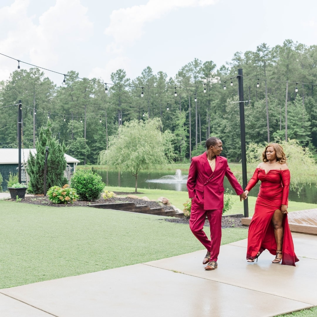 The couple walking in front of the beautiful pond on the pinehill pavilion pond. 