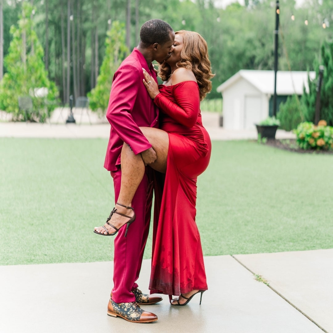 This picture depicts the couple kissing and Alexus raising her leg. 