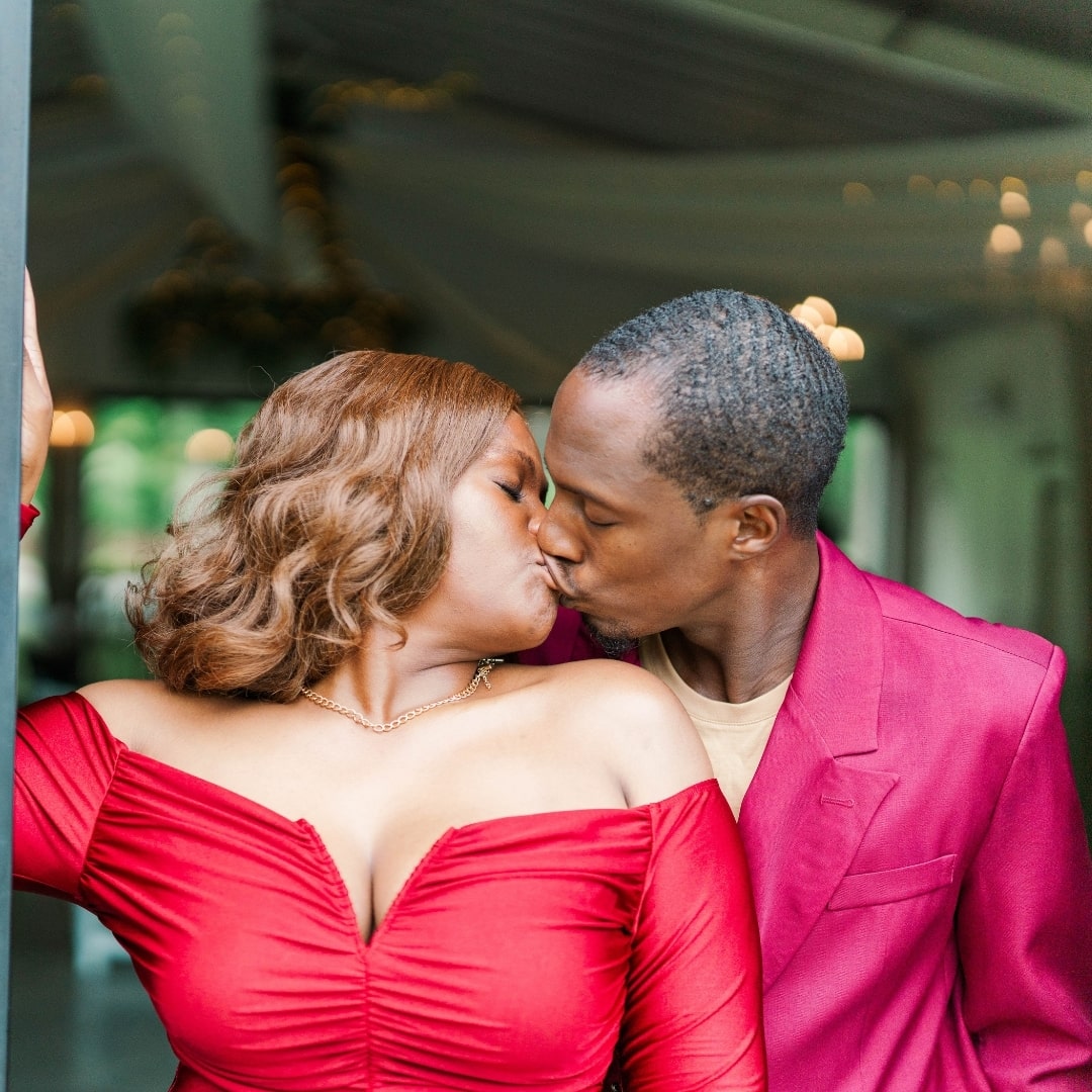 The couple kissing in the back of the pinehill pavilion venue. 