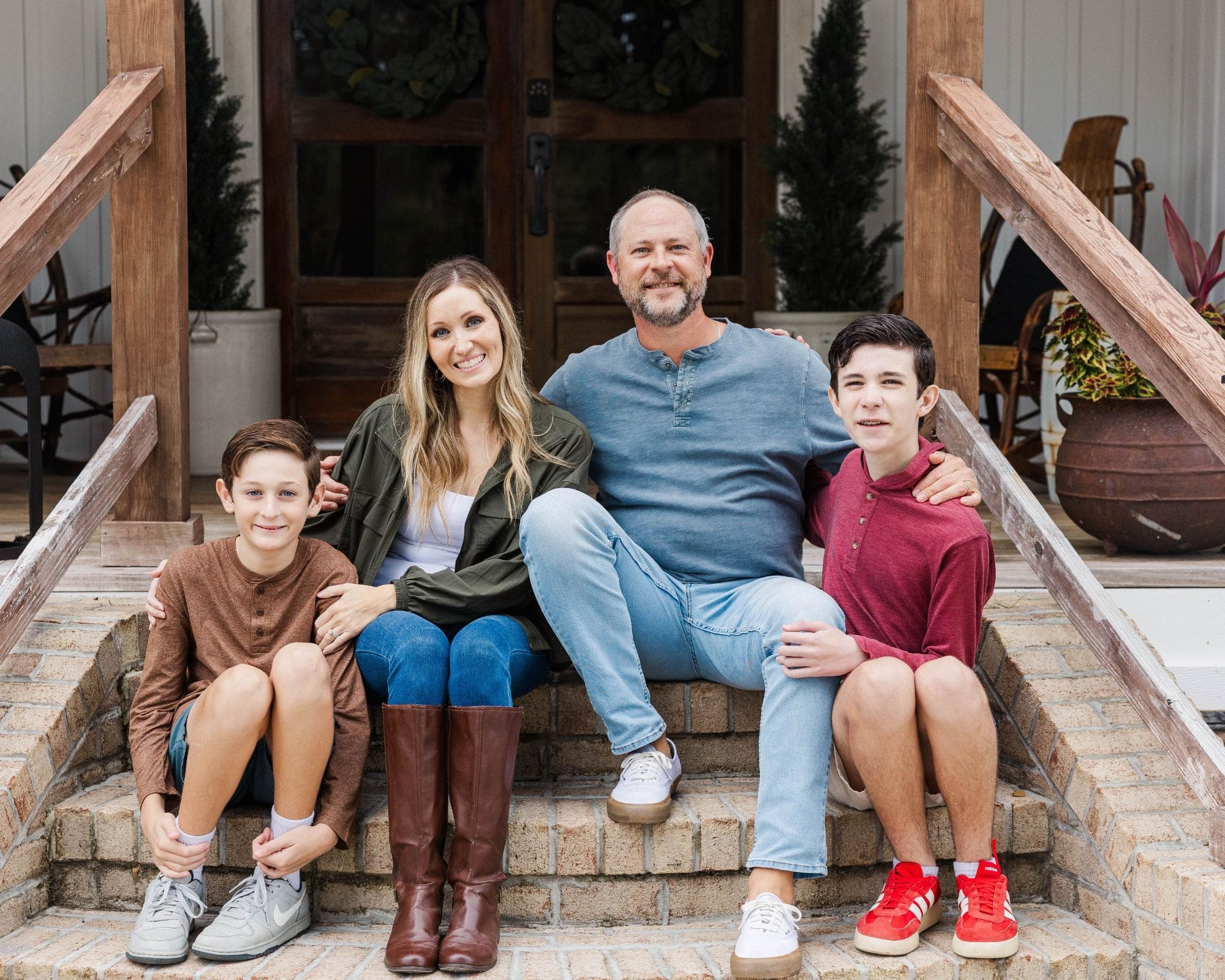 Young family twirling together at golden hour on Weeks Farm in Newport, NC