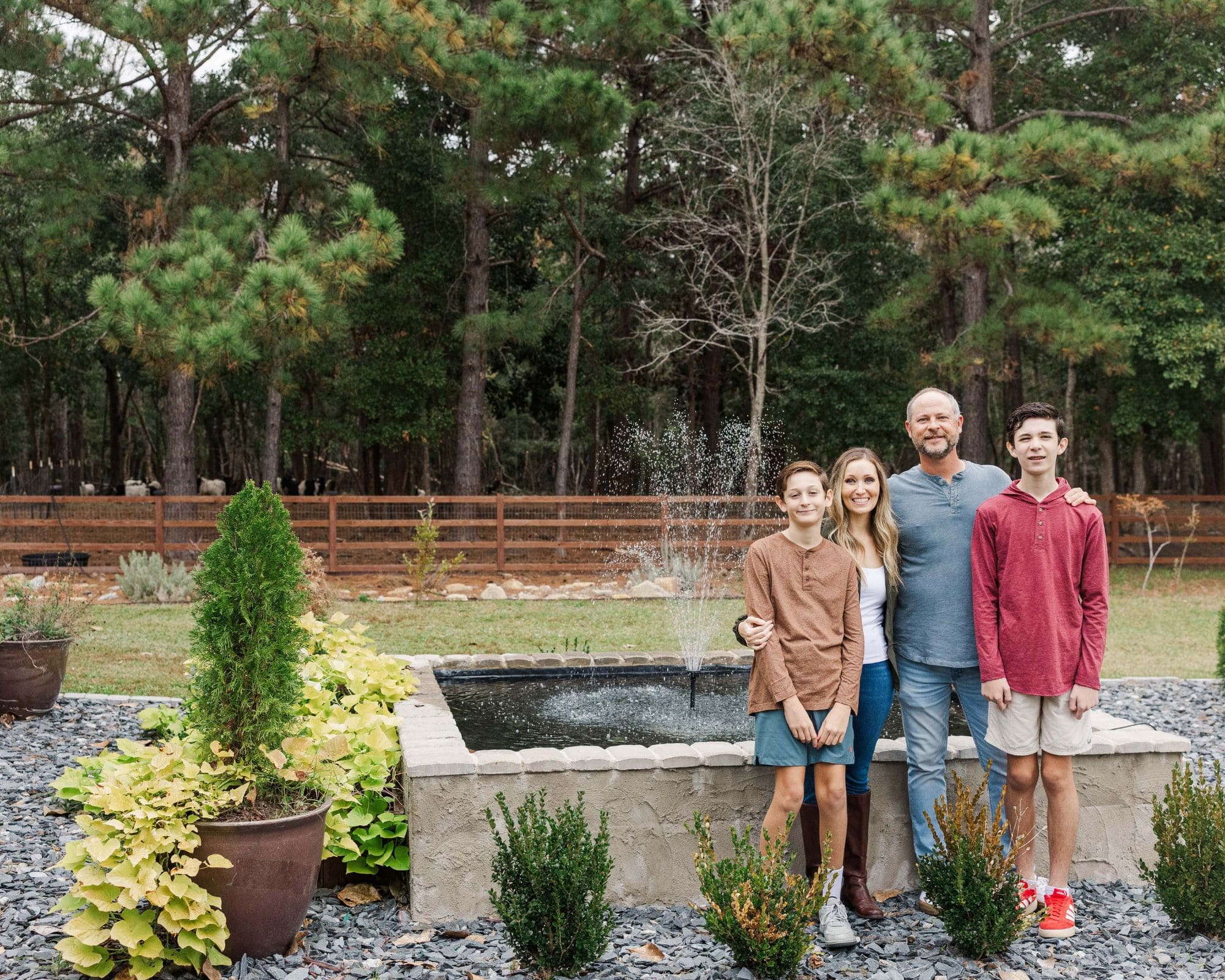 family standing near a water fountain for their family portraits