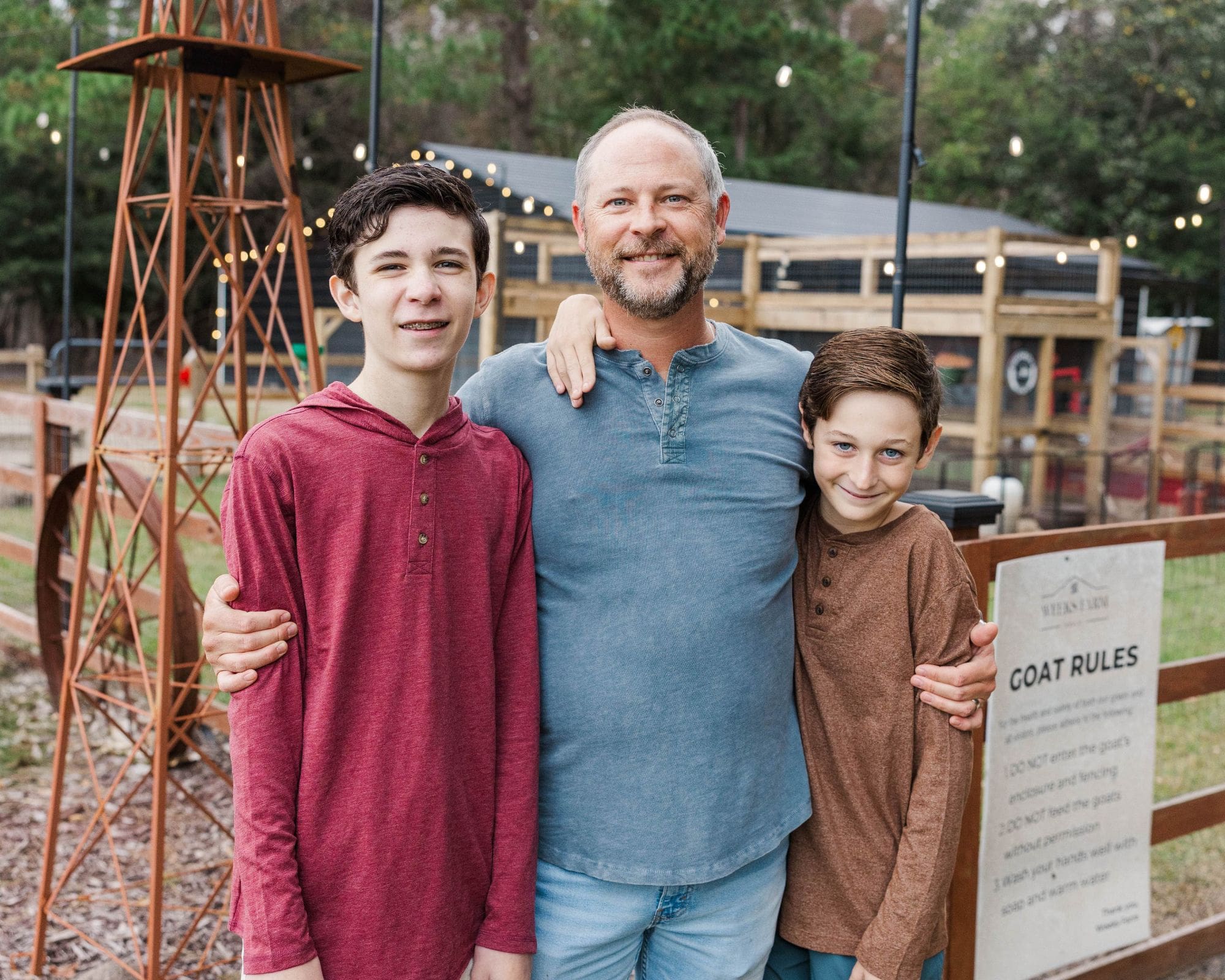 Parent and child sharing a quiet moment under a tree at Weeks Farm in Newport, NC
