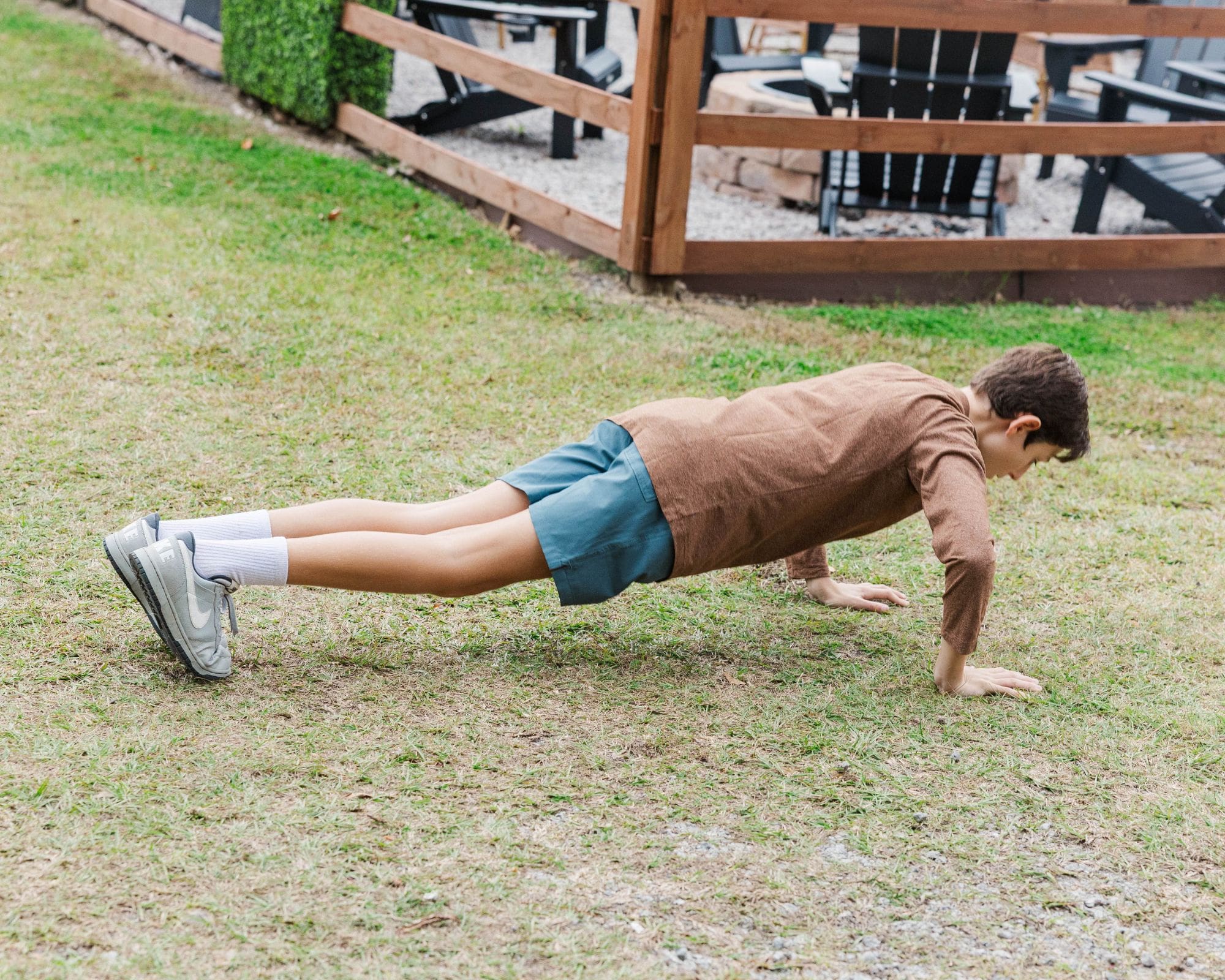 Child doing pushups in the middle of the family session